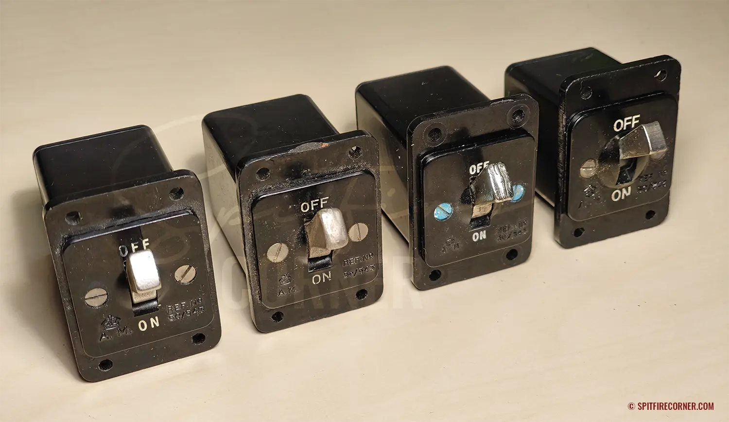 Four original Air Ministry Switch Type B (5C/543) switches photographed side by side, selected to illustrate the range of construction differences found across examples bearing the same stores reference