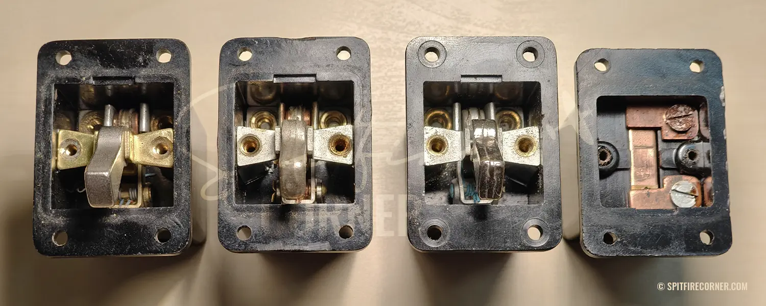 Four Air Ministry Switch Type B (5C/543) switches opened and viewed from the front, comparing the AP1095A-standard snap-action mechanism of switches 1 to 3 with the entirely different spring-plate mechanism of switch No. 4